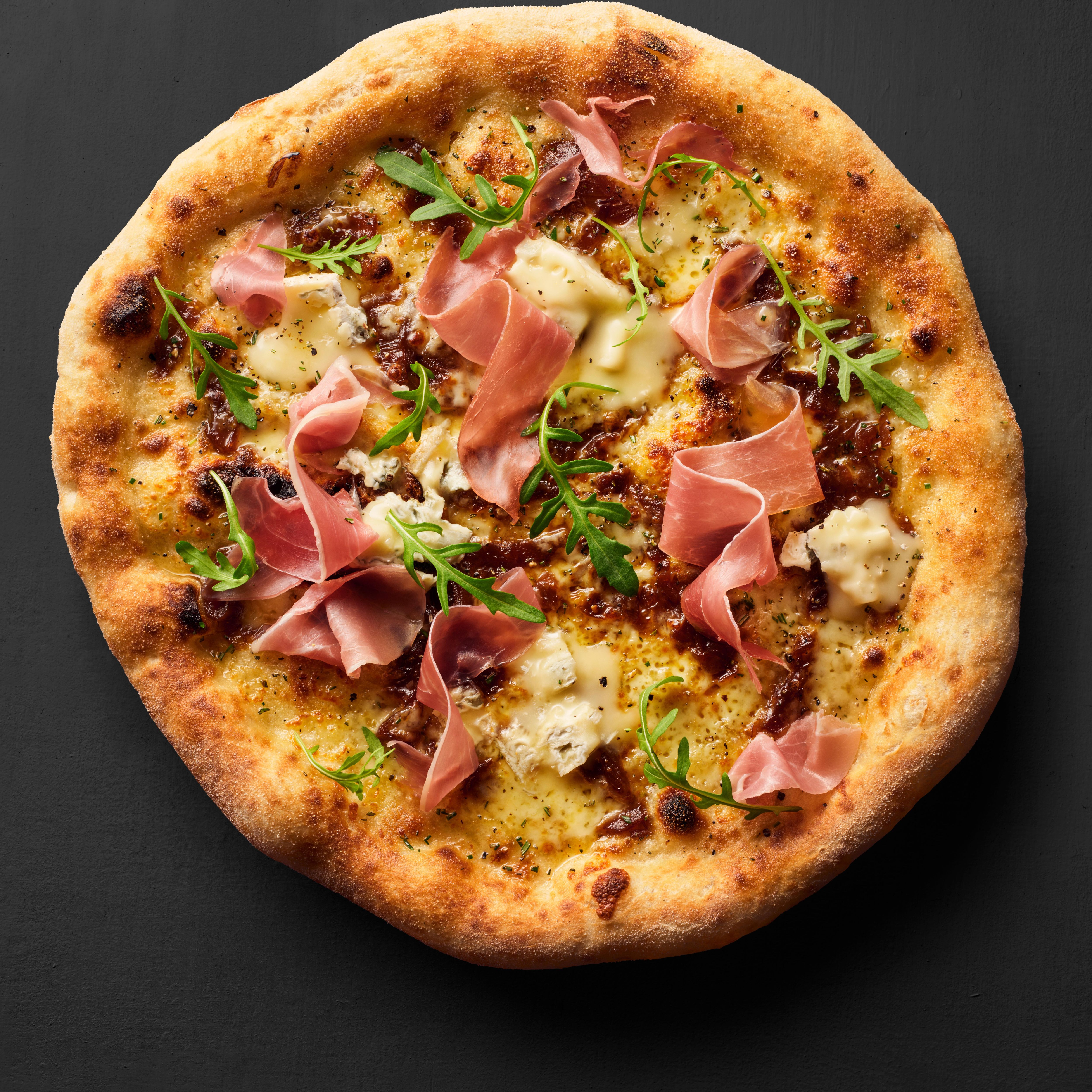 Close up of a prosciutto pizza 