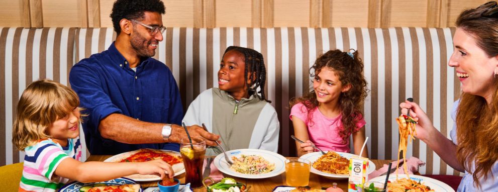 Someone eating pasta and a salad at Prezzo