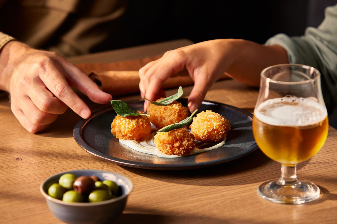 People sharing arancini